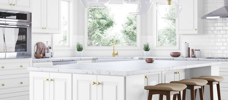 A kitchen with white tile backsplash and matching white Shaker cabinets